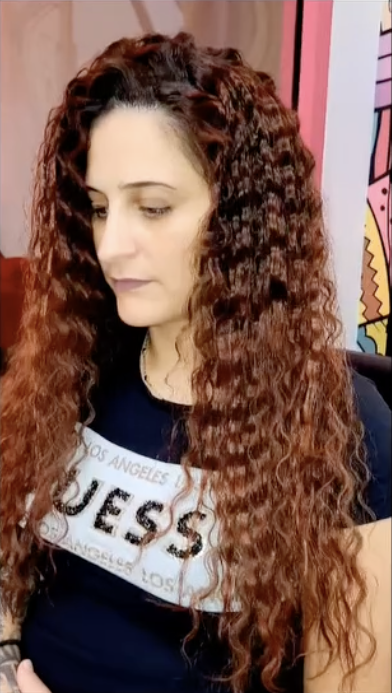 Long auburn curls styled by Shazz