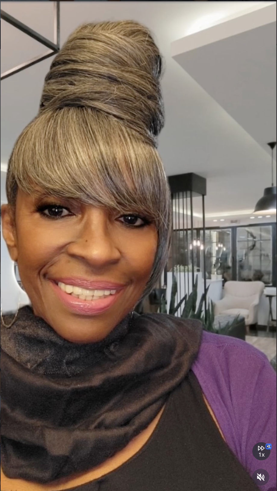 Sleek high bun with swept bangs